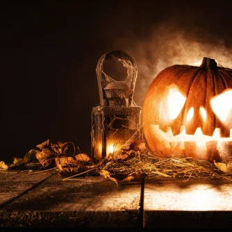 Scary halloween pumpkin on wooden planks.